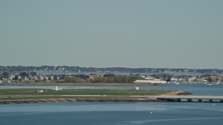 5.5K aerial stock footage tracking a commercial airplane landing, Logan International Airport, Massachusetts Aerial Stock Footage | AX142_287