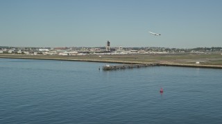 5.5K aerial stock footage tracking commercial plane taking off, Logan International Airport, Massachusetts Aerial Stock Footage | AX142_290