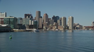 5.5K aerial stock footage flying low by Rowes Wharf, approaching Downtown Boston, Massachusetts Aerial Stock Footage | AX142_291E