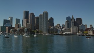 5.5K aerial stock footage flying low by Rowes Wharf and the skyline, Downtown Boston, Massachusetts Aerial Stock Footage | AX142_295E