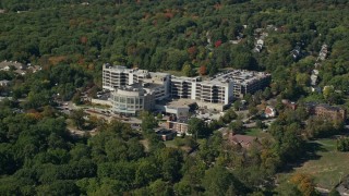 5.5K aerial stock footage flying by Faulkner Hospital, colorful trees, autumn, Jamaica Plain, Massachusetts Aerial Stock Footage | AX142_313E