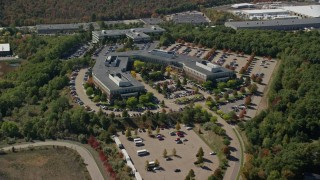 5.5K aerial stock footage approaching, flying over office building, tilt down, autumn, Westwood, Massachusetts Aerial Stock Footage | AX142_324