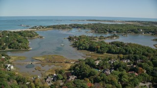 5.5K aerial stock footage flying over forest, approach small coastal community, autumn, Cohasset, Massachusetts Aerial Stock Footage | AX143_024E