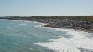 5.5K aerial stock footage flying by waves rolling onto beach, coastal community, Scituate, Massachusetts Aerial Stock Footage | AX143_035E