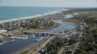 AX143_050E - 5.5K aerial stock footage of a small coastal community, Broad Creek, small bridge, Humarock, Massachusetts