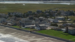 5.5K aerial stock footage approaching beachfront homes, rolling waves, beach, Duxbury, Massachusetts Aerial Stock Footage | AX143_064E