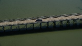 5.5K aerial stock footage orbiting Powder Point Bridge, tracking a black car, Duxbury, Massachusetts Aerial Stock Footage | AX143_075E