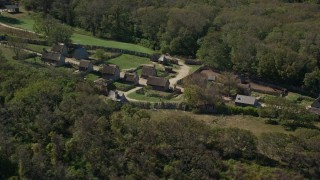 AX143_106E - 5.5K aerial stock footage orbiting Plimoth Plantation, green trees, Plymouth, Massachusetts