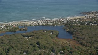 5.5K aerial stock footage flying by small coastal community, reveal Bartlett Pond, Plymouth, Massachusetts Aerial Stock Footage | AX143_117E