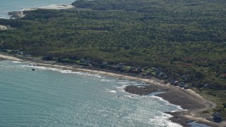 AX143_124 - 5.5K aerial stock footage flying over Cape Cod Bay, by beachfront homes, Plymouth, Massachusetts