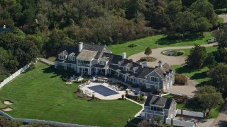 AX143_166E - 5.5K aerial stock footage orbiting mansion, green lawns, Cape Cod, Dennis, Massachusetts