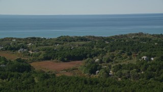 5.5K aerial stock footage flying by forest, homes with ocean views, Cape Cod, Truro, Massachusetts Aerial Stock Footage | AX143_201