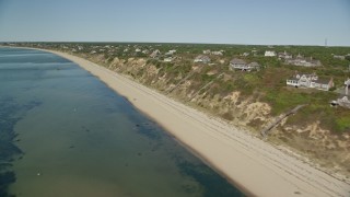 5.5K aerial stock footage flying by beach, homes with ocean views, Cape Cod, Truro, Massachusetts Aerial Stock Footage | AX143_208E