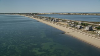 AX143_215E - 5.5K aerial stock footage flying over beachfront homes, Highway 6, coastal road, Truro, Massachusetts