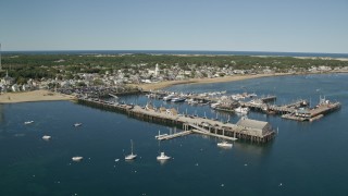 5.5K aerial stock footage orbiting piers, near small coastal town, Provincetown, Massachusetts Aerial Stock Footage | AX143_224E