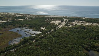 AX143_251E - 5.5K aerial stock footage flying by Highway 6, a coastal road, Provincetown, Massachusetts