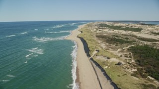 AX144_004E - 5.5K aerial stock footage flying over waves rolling onto the beach, Cape Cod, Provincetown, Massachusetts