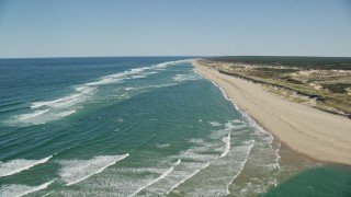 5.5K aerial stock footage flying over waves rolling onto beach, Cape Cod, Truro, Massachusetts Aerial Stock Footage | AX144_010E