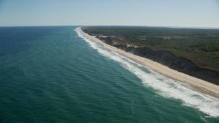 AX144_017E - 5.5K aerial stock footage flying by waves crashing onto beaches,Truro, Massachusetts