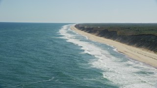 AX144_024E - 5.5K aerial stock footage approaching waves crashing onto beaches, Cape Cod, Wellfleet, Massachusetts