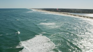 5.5K aerial stock footage flying low over waves rolling into the beach, Cape Cod, Orleans, Massachusetts Aerial Stock Footage | AX144_036E