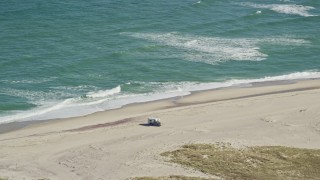 AX144_044 - 5.5K aerial stock footage flying by camper parked on beach, Cape Cod, Orleans, Massachusetts