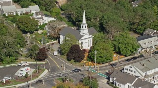 AX144_051 - 5.5K aerial stock footage flying by small town church, colorful trees, Cape Cod, Chatham, Massachusetts