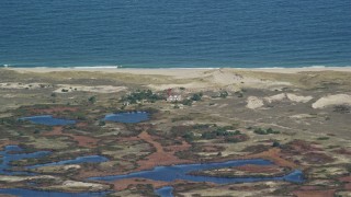 5.5K aerial stock footage flying by lighthouse on Monomoy Island, Cape Cod, Massachusetts Aerial Stock Footage | AX144_063