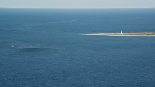 AX144_071E - 5.5K aerial stock footage of a Coast Guard helicopter, rescue practice, Great point Light, Nantucket, Massachusetts