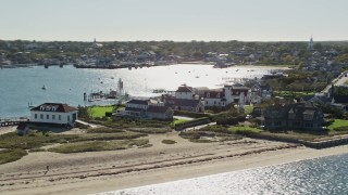 AX144_075E - 5.5K aerial stock footage flying by small island town, Nantucket Harbor Range Lights, Nantucket, Massachusetts