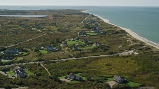 AX144_108E - 5.5K aerial stock footage flying over beachfront upscale homes, coastal community, Nantucket, Massachusetts