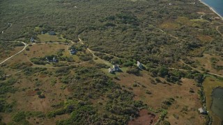 AX144_118 - 5.5K aerial stock footage approaching, tilt down on homes, Tuckernuck Island, Nantucket, Massachusetts