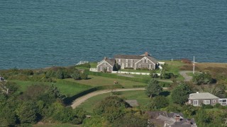 AX144_145 - 5.5K aerial stock footage flying by oceanfront home, Edgartown, Martha's Vineyard, Massachusetts