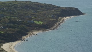 AX144_161 - 5.5K aerial stock footage flying by beachfront homes, Aquinnah, Martha's Vineyard, Massachusetts