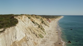 AX144_164 - 5.5K aerial stock footage video flying by coastal cliffs, reveal homes, Aquinnah, Martha's Vineyard, Massachusetts