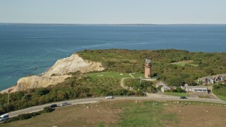 AX144_165E - 5.5K aerial stock footage flying by Gay Head Light, coastal cliff, Aquinnah, Martha's Vineyard, Massachusetts