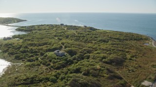 6k aerial stock footage flying by oceanfront homes, Cuttyhunk Island, Elisabeth Islands, Massachusetts Aerial Stock Footage | AX144_178