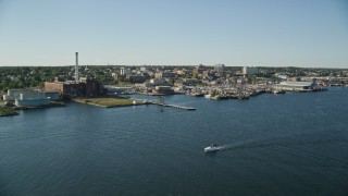 AX144_192E - 6k aerial stock footage of a pier, fishing boats, coastal community, factories, New Bedford, Massachusetts