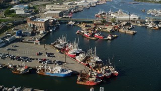 6k aerial stock footage tilting down, fly over over piers, fishing boats, New Bedford, Massachusetts Aerial Stock Footage | AX144_195