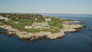 AX144_252 - 6k aerial stock footage flying by oceanfront mansion, coastal cliffs, Newport, Rhode Island