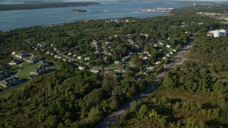 6k aerial stock footage flying over coastal homes, dense trees, lawns, Portsmouth, Rhode Island Aerial Stock Footage | AX145_004