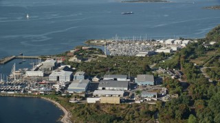 6k aerial stock footage flying over the coast, approaching marinas, warehouses, Portsmouth, Rhode Island Aerial Stock Footage | AX145_005E