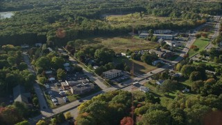 AX145_023E - 6k aerial stock footage flying by Wampanoag Trail, dense trees, Barrington, Rhode Island