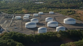 AX145_026 - 6k aerial stock footage approaching and flying by large storage tanks, Riverside, Rhode Island