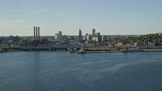 AX145_031E - 6k aerial stock footage flying by power plant, smoke stacks and Downtown Providence, Rhode Island