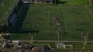 AX145_064E - 6k aerial stock footage approaching a football practice, Brown University, Providence, Rhode Island