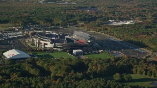 6k aerial stock footage flying away from Gillette Stadium, trees, autumn, Foxborough, Massachusetts Aerial Stock Footage | AX145_111