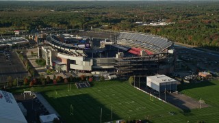 AX145_117E - 6k aerial stock footage approaching Gillette Stadium, tilt down, autumn, Foxborough, Massachusetts