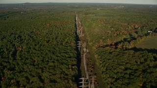 6k aerial stock footage flying by deciduous forest, power lines, autumn, Walpole, Massachusetts Aerial Stock Footage | AX145_125E