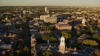 AX146_020 - 6k aerial stock footage orbiting Eliot House, reveal Lowell House, Harvard University, Massachusetts, sunset